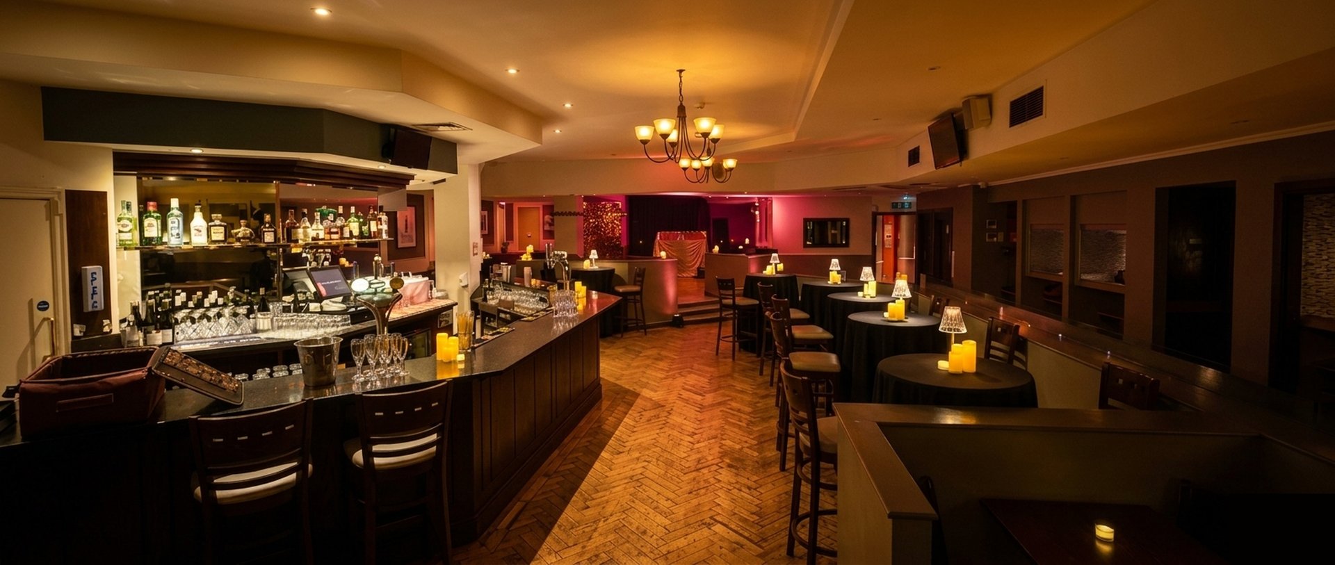 Steam Wine Bar interior — the full venue set for an evening, bar to stage, candlelit and atmospheric